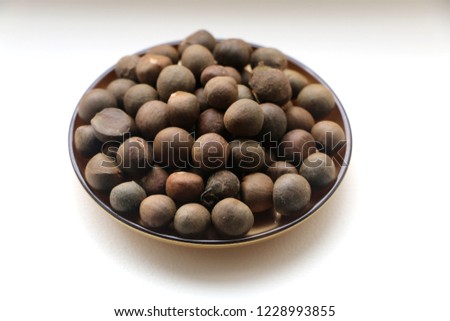 plate with tea seeds on white background Royalty-Free Stock Photo #1228993855