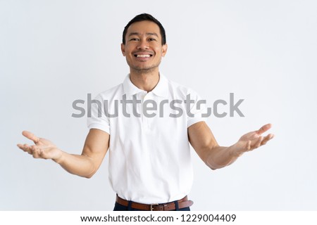 Happy Latin guy outstretching hands and ready to hug old friend. Friendly young man opening arms in welcoming gesture. Choice concept