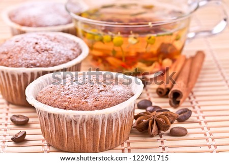 Chocolate muffins with a herbal tea and cinnamon