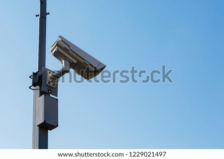 Security camera on blue sky background. Security view post