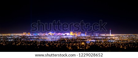 Las Vegas strip and city skyline at night panorama with casino lights and hotels from a far distance Royalty-Free Stock Photo #1229028652