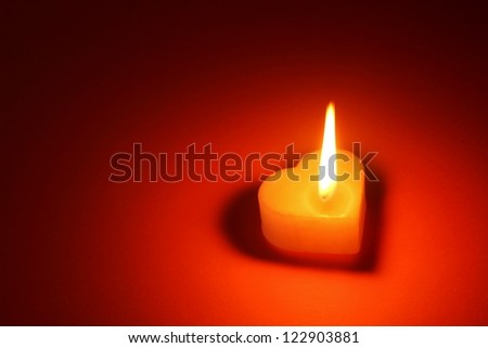 Heart shaped candle on love theme
