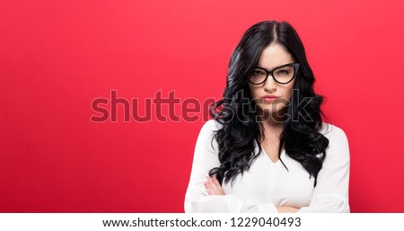 Unhappy young woman on a solid background Royalty-Free Stock Photo #1229040493
