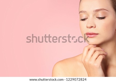 Portrait of beautiful young woman and space for text on color background. Cosmetic surgery concept