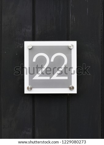 House number 22 on wooden wall happy new home moving away modern door number twenty two 