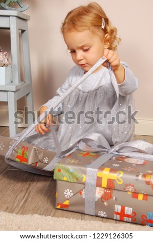 Bright picture of happy child with gift box.