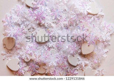White artificial snowflakes on soft light background. Winter background. Decorative template for cards, banner, poster.