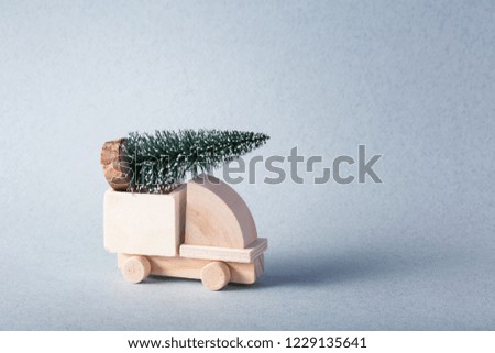 Wooden toy truck with christmas tree on is top