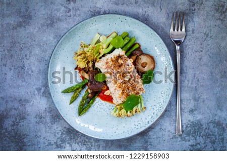 Halibut with hazelnut crust with roast red pepper sauce, asparagus, cauliflower and shiitake mushrooms