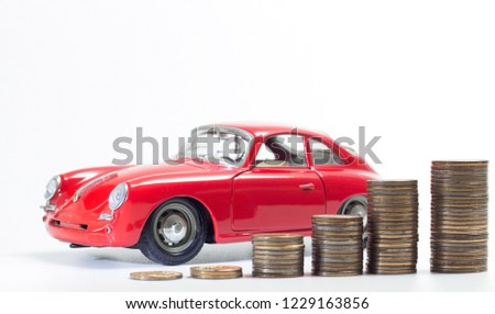Image similar to a pile of silver coins with a red sports car model in a savings concept to buy a car or insure on a travel trip.