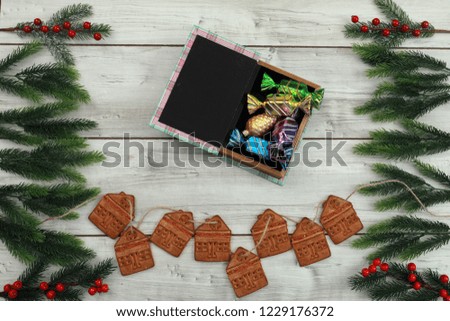 Merry Christmas and Happy New Year wood background. Biscuits,  fir branch,  stars,snowflakes,gift.