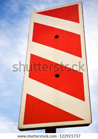 Vertical red white stripped road sign