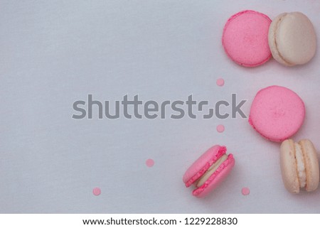 Sweet white and pink French macaroons on a white background, canvas. Beautiful breakfast with macaroon. Flat lay.