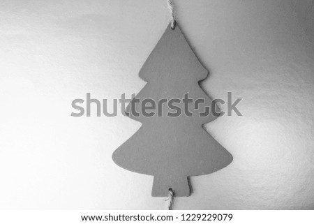 Festive Christmas Christmas winter happy beautiful beautiful black and white background with a small toy wooden homemade cute Christmas tree. Flat lay. Top view. Holiday decorations.