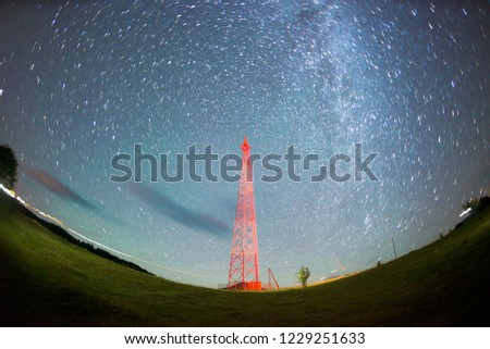 a trip in the mountains at night near the mobile signal tower tower in Ukraine in the Carpathians Ukraine. Metal red design against the background of a huge starry sky is very beautiful
