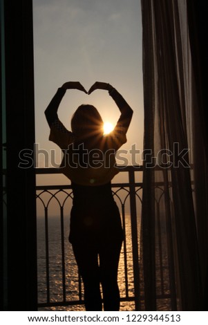 alone girl siluette on balcony in sunset