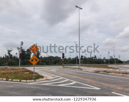 The view of a new intersection with modern traffic lights and clearer signboards
