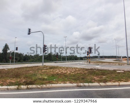 The view of a new intersection with modern traffic lights and clearer signboards
