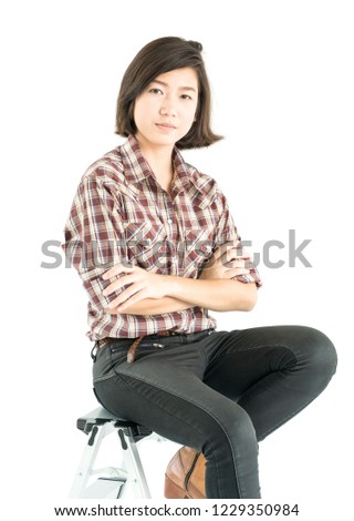 Young pretty woman in plaid shirt posing in studio with isolated on white background