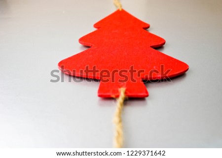 Festive Christmas Christmas winter happy beautiful gray silver shiny background with a small toy wooden homemade cute Christmas tree. Flat lay. Top view. Holiday decorations.