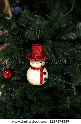 Decorated Christmas tree with small snowman and colorful ball. Christmas theme.