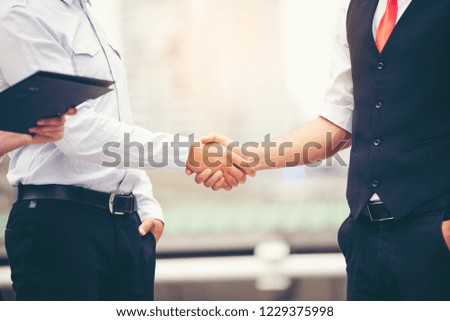 Closeup of business man handshake outdoor,teamwork, achieve , confirmation of business alliance partners , commitment  in business,partnership deal,selective focus,copy space.