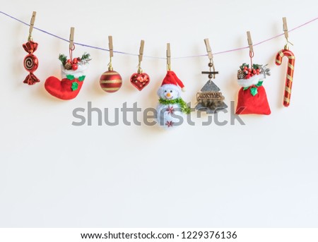 Christmas  decorations  hanging  on  the  colorful  rope  with  white  background