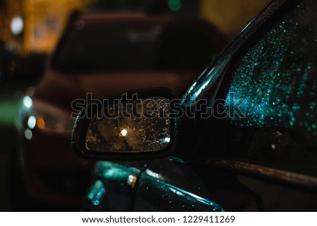 Night rain drops on the surface of the car, abstract background