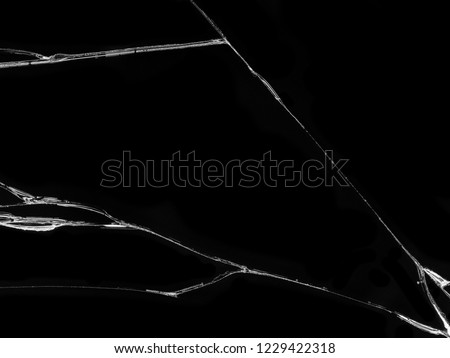 Cracked glass texture on black background. Isolated realistic cracked glass effect. Royalty-Free Stock Photo #1229422318