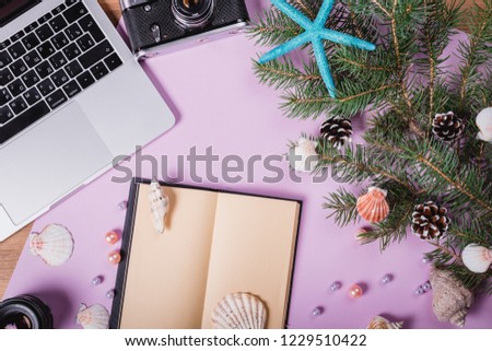 Calendar and tropical leave on blue background. Holiday and travel plan. Christmas card. Top view, copy space. Flat lay.