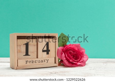 Wooden calendar show of February 14 on wooden tabletop