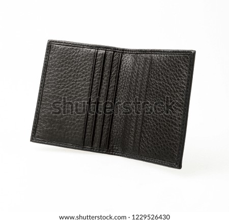 Opened black purse erected in white background