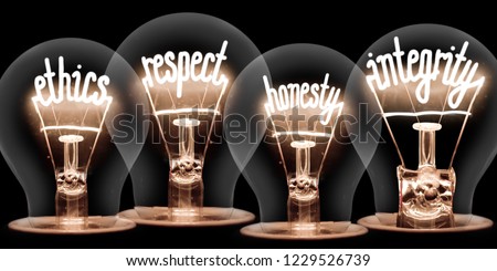 Photo of light bulbs with shining fibres in ETHICS, RESPECT, HONESTY and INTEGRITY shape isolated on black background Royalty-Free Stock Photo #1229526739