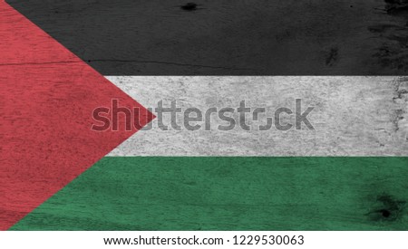 Flag of Palestine on wooden plate background. Grunge Palestine flag texture, a horizontal tricolor of black, white, and green; with a red triangle based at the hoist.
