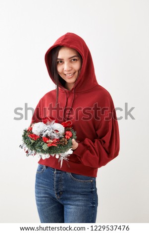 A young girl with a wreath of Christmas wreath