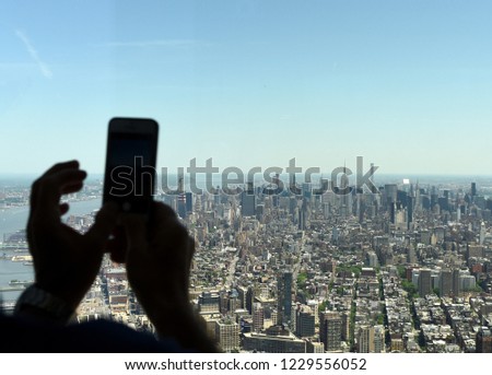 Man make a pictures on smartphone of the New York cityscape. Top view on the New York.