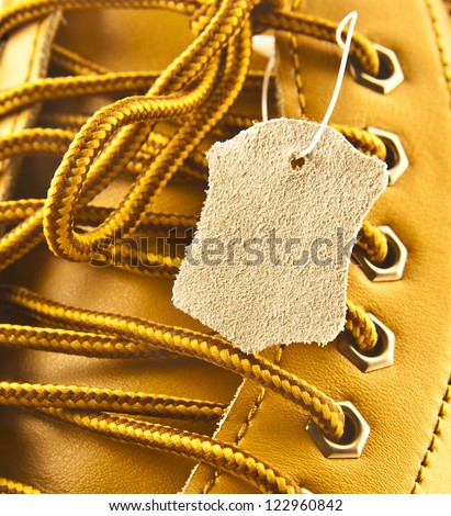 closeup of new yellow leather shoes with label
