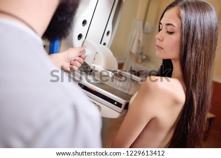 Doctor Standing Assisting Patient Undergoing Mammogram X-ray Tes. Prevention of breast cancer