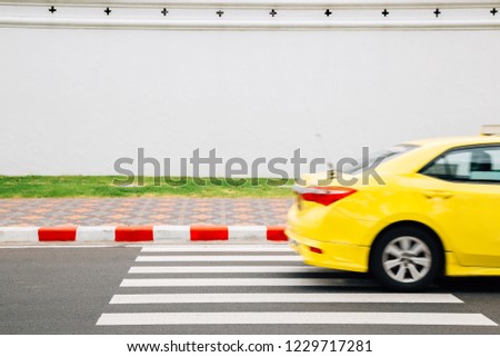 Yellow taxi on crosswalk road