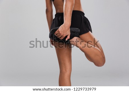 Cropped photo of amazing young strong sports woman make exercises isolated.