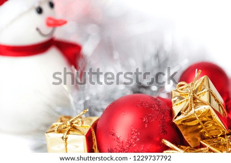 Merry Christmas, New Year, snowman, gifts in golden boxes and red balls on a blue and white bokeh background.