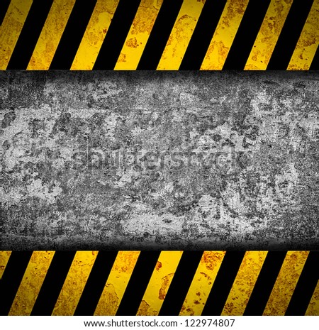 Grunge metal background with black and yellow warning stripes