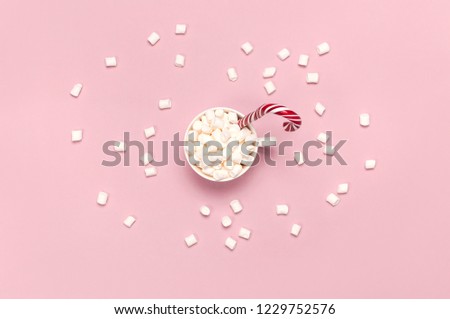 Christmas New Year drink, white mug with marshmallows and Candy Cane on pink background top view Flat Lay copy space. Winter traditional drink food. Festive decor, celebration Xmas holiday 2019