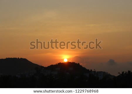 sun set from car window closeup background street lights mountains