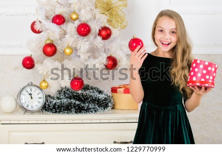 Opening christmas presents. Dreams come true. Surprise concept. Kid girl near christmas tree hold gift box. Child celebrate christmas at home. Favorite day of the year. Time to open christmas gifts.