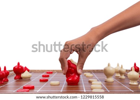 Boy's hand playing chess isolated on white background.
