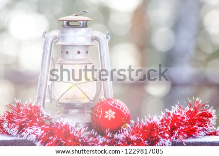 Vintage lantern and Christmas decorations on the background of a beautiful bokeh in winter