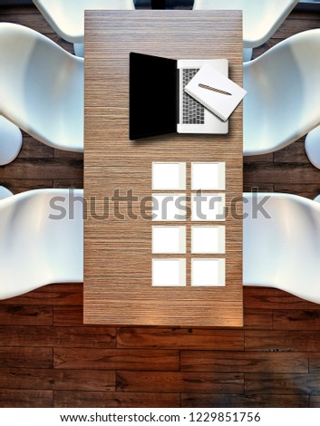 Top view from above on laptop on wooden table, plastic chairs and hardwood floor