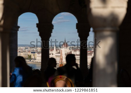 View of Hungarian Parliament Building in Budapest from the top of Buda Castle, Fisherman's Bastion. People enjoying the cityscape view