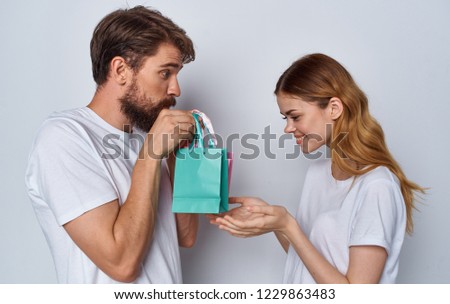 man with gift bag and happy woman                              
